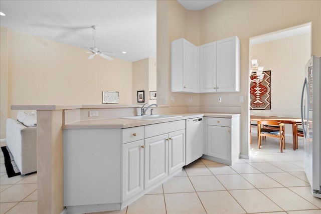 kitchen with white cabinets, white appliances, and kitchen peninsula