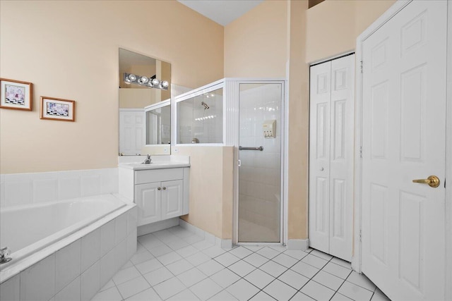 bathroom with tile patterned flooring, vanity, and separate shower and tub