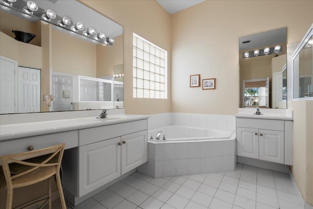 bathroom with a wealth of natural light, tile patterned flooring, vanity, and shower with separate bathtub