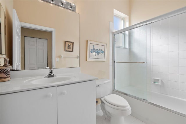 full bathroom with tile patterned flooring, vanity, enclosed tub / shower combo, and toilet