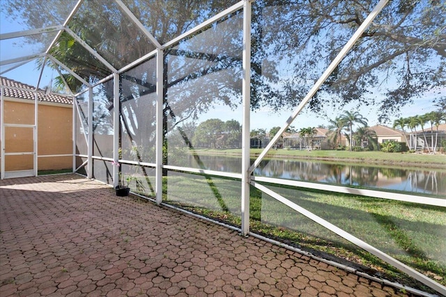 unfurnished sunroom with a water view