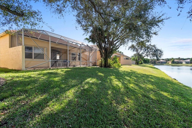 view of yard featuring a lanai and a water view