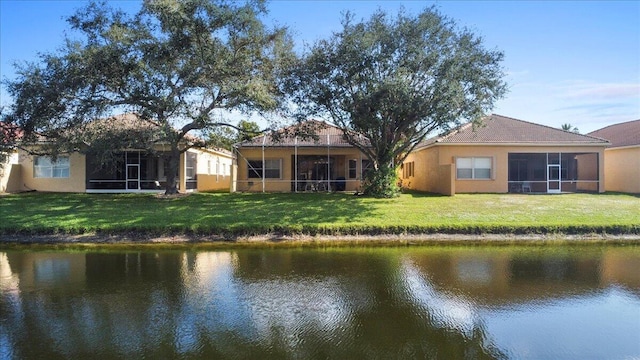 back of property featuring a yard and a water view