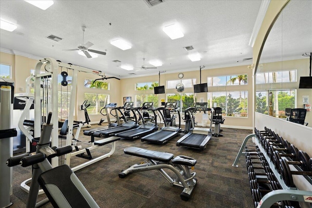 exercise room featuring ceiling fan, crown molding, and a textured ceiling