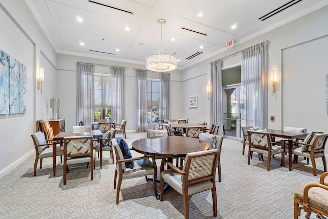 dining room with light colored carpet, crown molding, and a chandelier