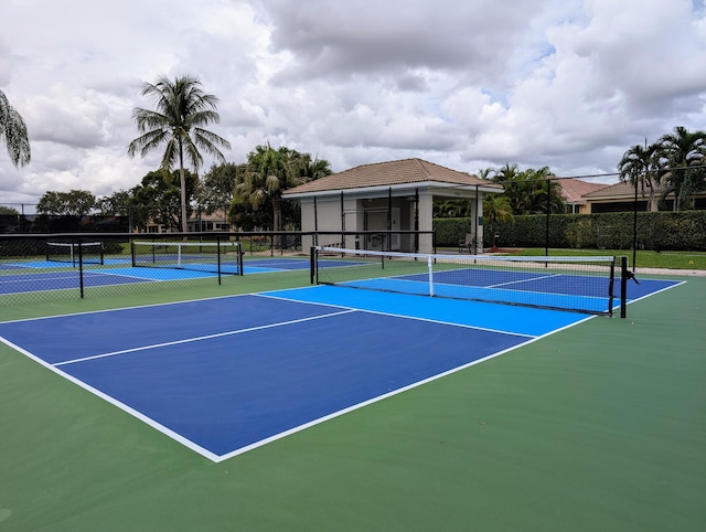 view of tennis court featuring basketball hoop