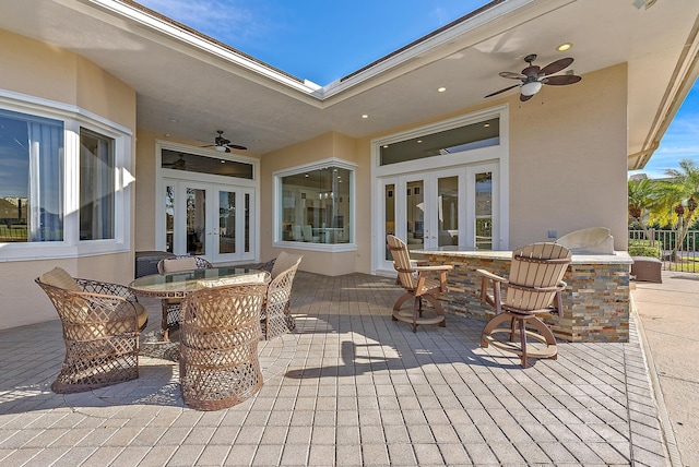 view of patio / terrace featuring french doors, ceiling fan, and exterior bar