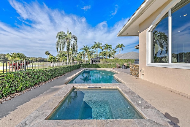 view of swimming pool featuring an in ground hot tub