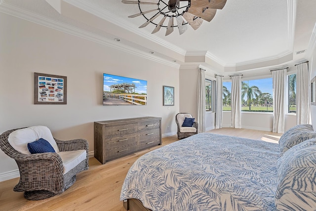 bedroom featuring crown molding, ceiling fan, and light wood-type flooring