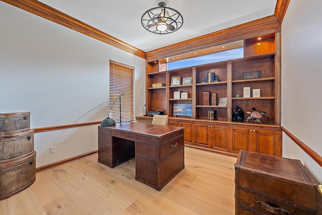 office with crown molding, light hardwood / wood-style floors, and a textured ceiling