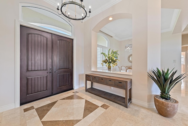 foyer entrance featuring an inviting chandelier and ornamental molding