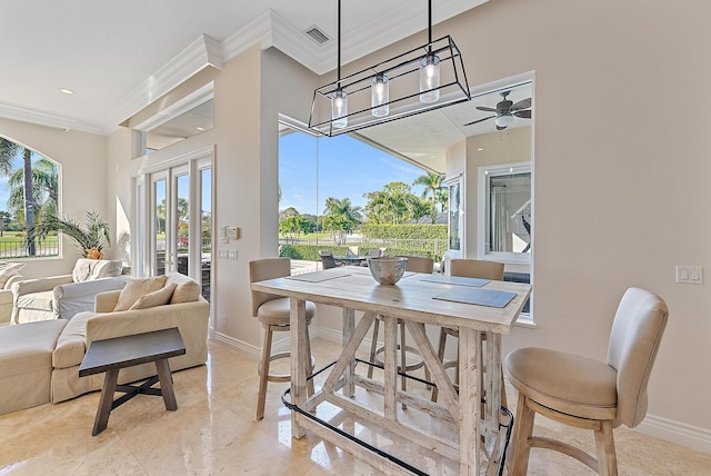 dining area with crown molding and ceiling fan with notable chandelier