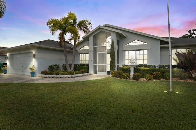 view of front of house with a yard and a garage