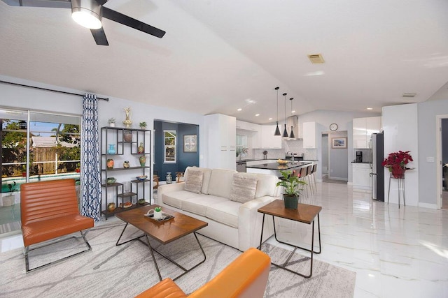 living room featuring vaulted ceiling and ceiling fan