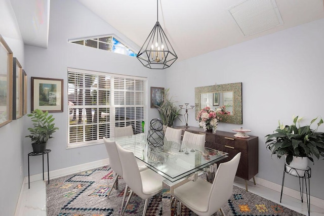 dining room featuring a chandelier and vaulted ceiling