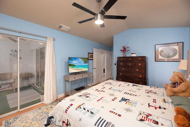 bedroom featuring wood-type flooring, lofted ceiling, and ceiling fan