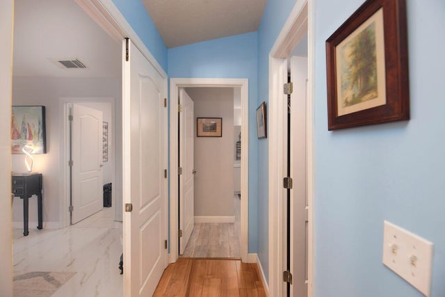 hallway with light wood-type flooring