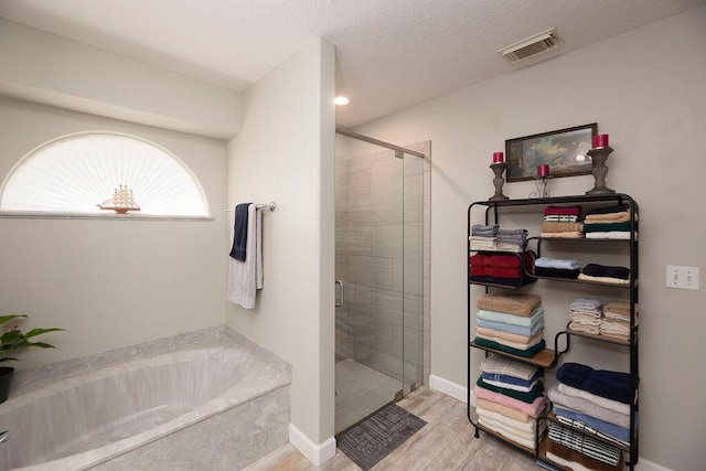 bathroom featuring hardwood / wood-style floors and plus walk in shower