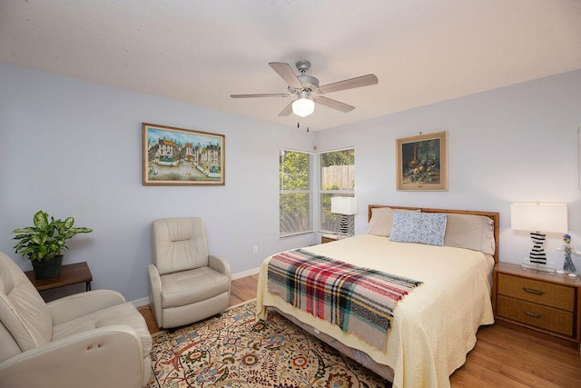 bedroom with ceiling fan and light hardwood / wood-style flooring