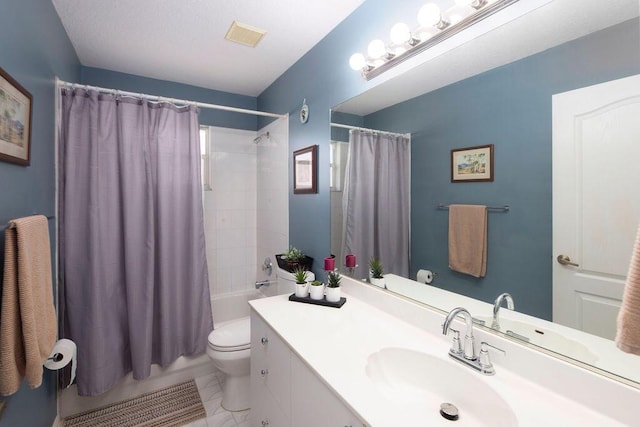 full bathroom with vanity, shower / tub combo, and toilet