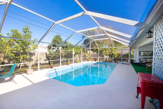 view of swimming pool with a lanai and a patio