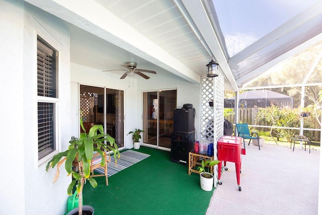 view of patio featuring a lanai and ceiling fan