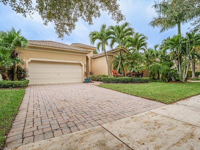 mediterranean / spanish house with a front lawn and a garage