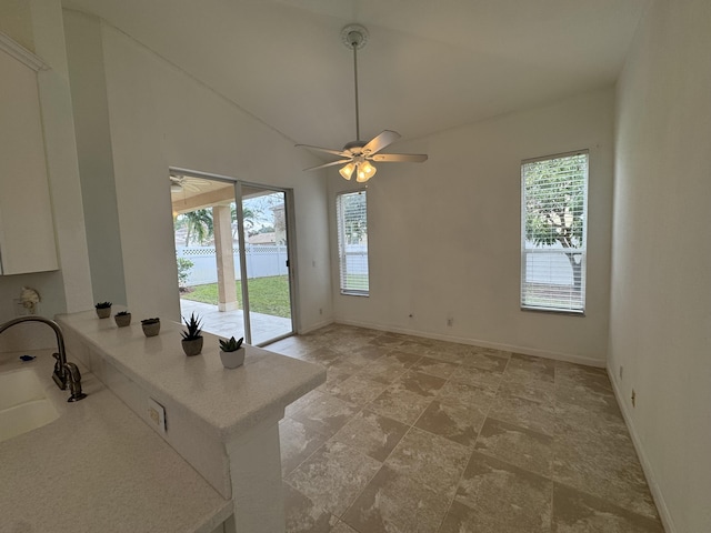 interior space with vaulted ceiling, ceiling fan, and sink