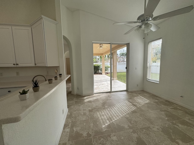 kitchen with white cabinets and ceiling fan