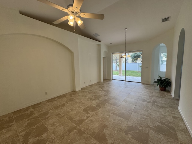 interior space with ceiling fan with notable chandelier