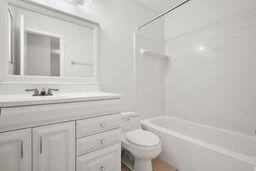 full bathroom featuring toilet, shower / washtub combination, and vanity