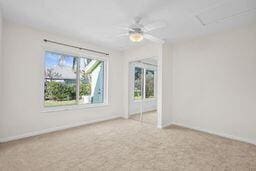 empty room featuring carpet flooring and ceiling fan