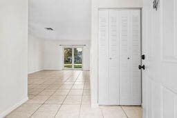 hall featuring light tile patterned flooring