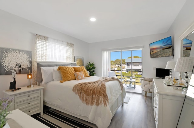 bedroom featuring light hardwood / wood-style floors, access to exterior, and multiple windows