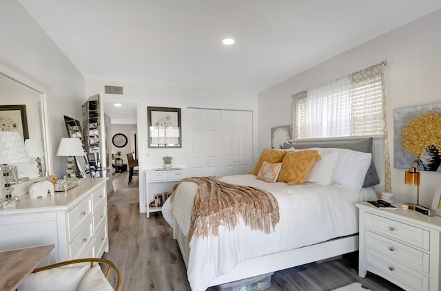 bedroom featuring wood-type flooring and a closet