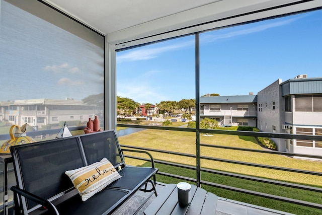 sunroom / solarium with a water view