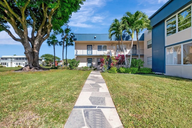 169 Flanders D, Delray Beach, FL 33484 - view of front of home with stucco siding and a front yard