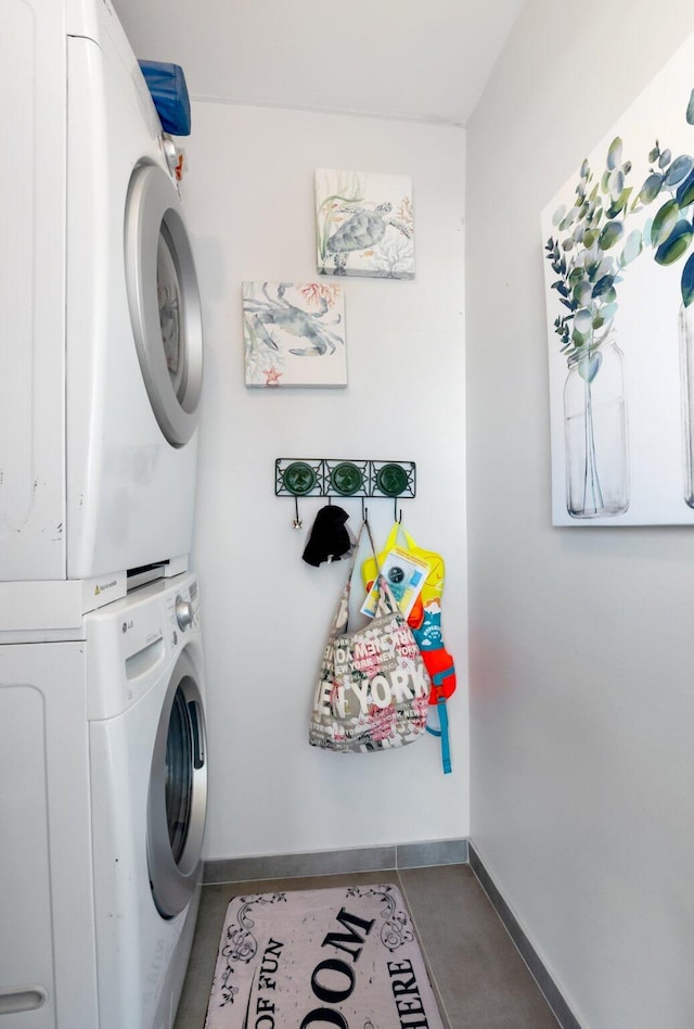 washroom featuring stacked washer and clothes dryer