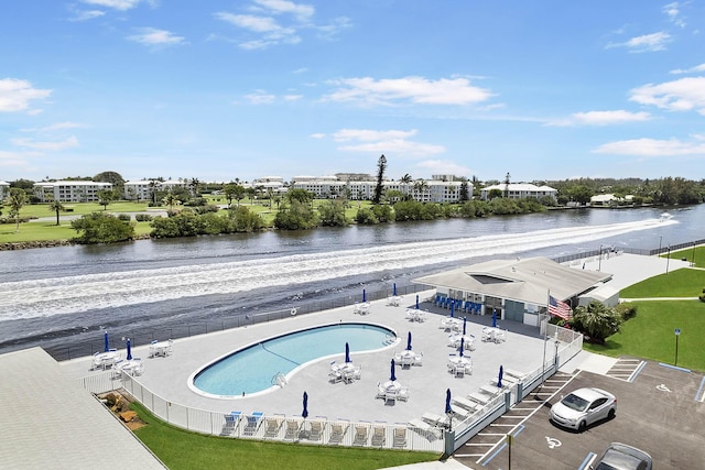 view of swimming pool with a water view