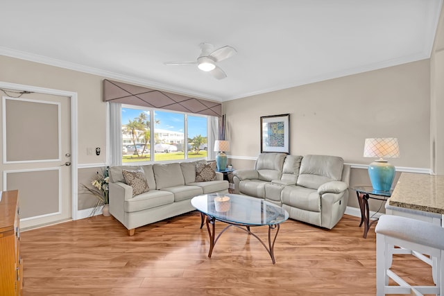 living room with ceiling fan, crown molding, and light hardwood / wood-style floors