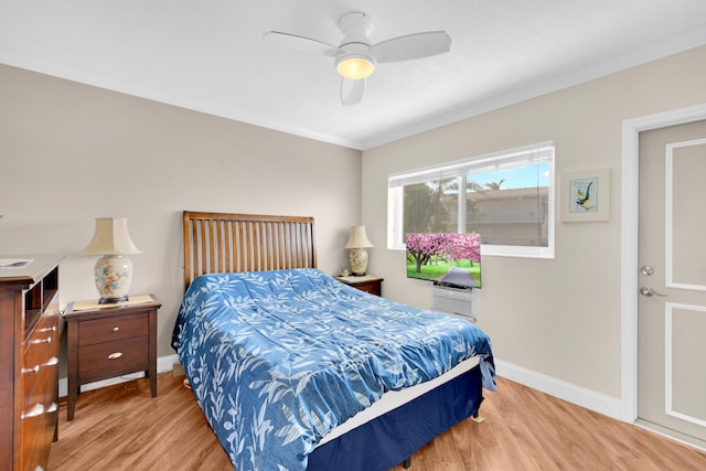 bedroom with hardwood / wood-style floors, ceiling fan, and ornamental molding