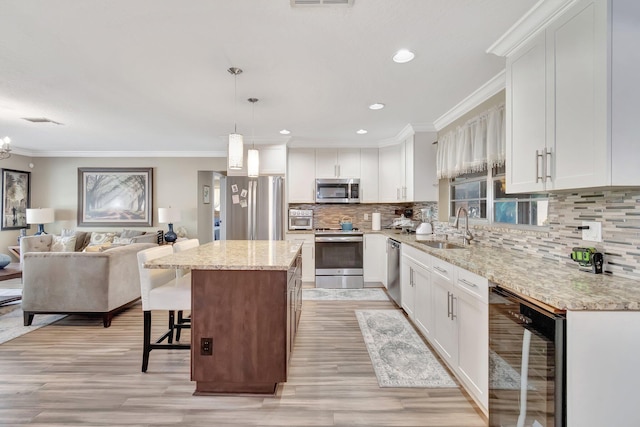 kitchen featuring white cabinets, appliances with stainless steel finishes, and sink