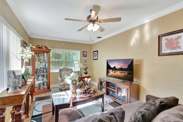 living room featuring hardwood / wood-style flooring, ceiling fan, and ornamental molding