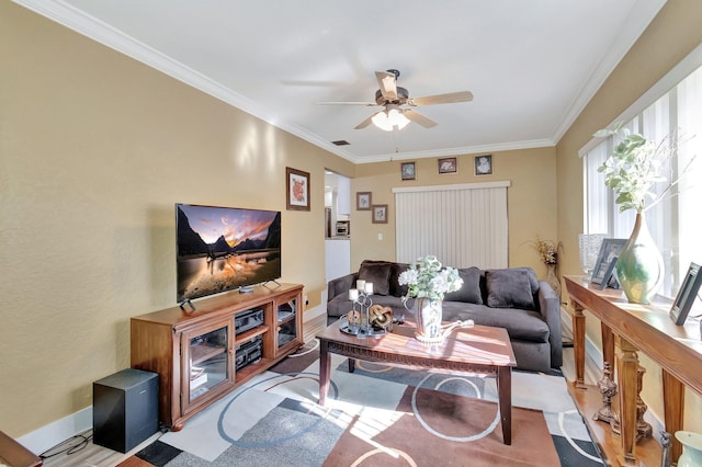 living room featuring ceiling fan and crown molding