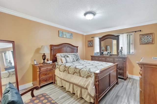 bedroom with a textured ceiling, light hardwood / wood-style floors, and crown molding