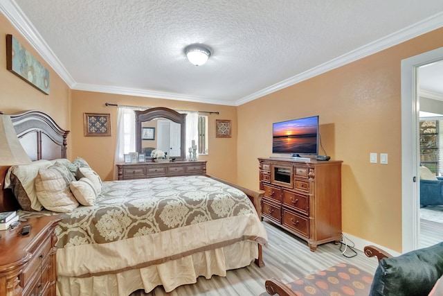 bedroom with access to exterior, a textured ceiling, multiple windows, and ornamental molding