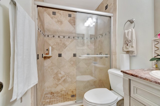 bathroom with vanity, toilet, and walk in shower