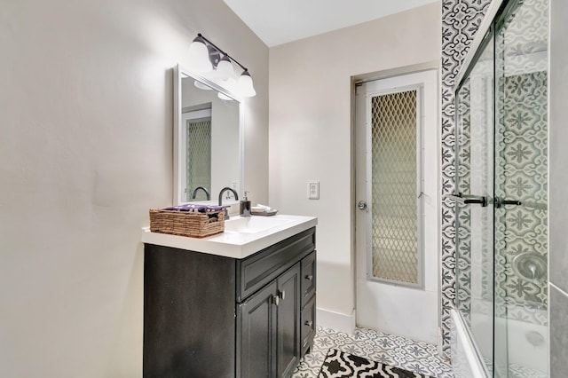 bathroom with shower / bath combination with glass door, vanity, and tile patterned floors