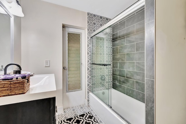 bathroom with tile patterned floors, vanity, and combined bath / shower with glass door