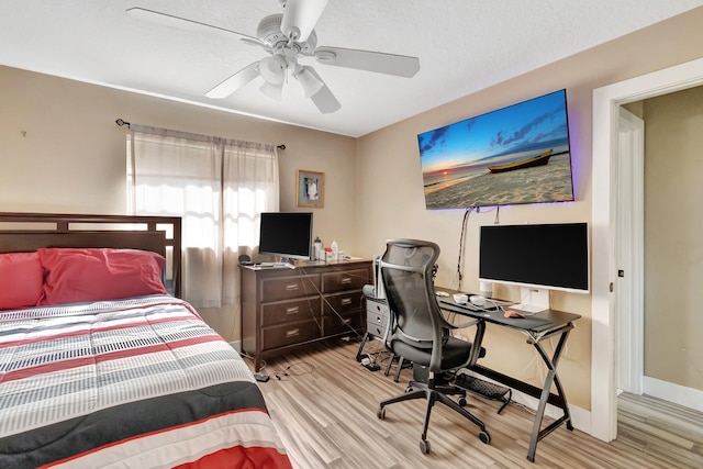 bedroom with ceiling fan and light wood-type flooring